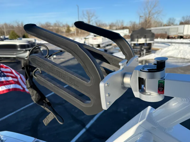 Slide: The Image of Wakeboard rack on 2025 Cobalt R6 Surf boat, outdoor setting. - 44