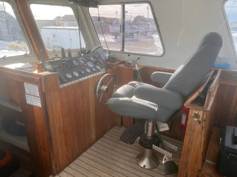 Slide: The Image of Interior of 1988 Young Brothers 40 boat with wooden helm and captain's chair. - 12