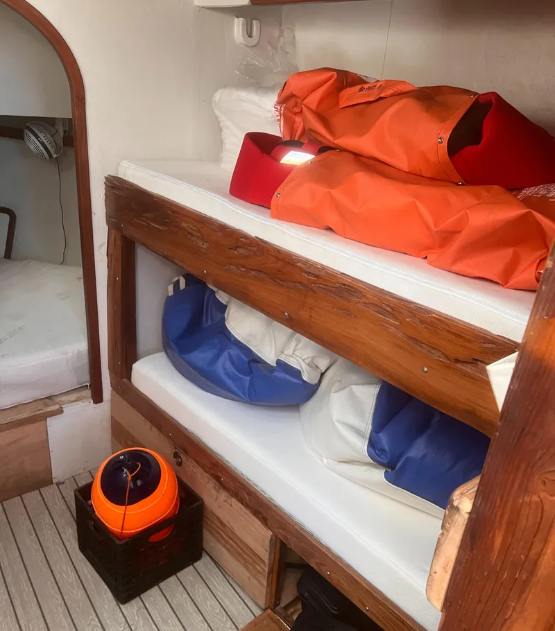 Slide: The Image of Interior of 1988 Young Brothers 40 boat with bunk beds and storage bags. - 14