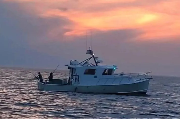 Slide: The Image of Fishing boat at sunset, Young Brothers 40, 1988 model, on calm ocean waters. - 2