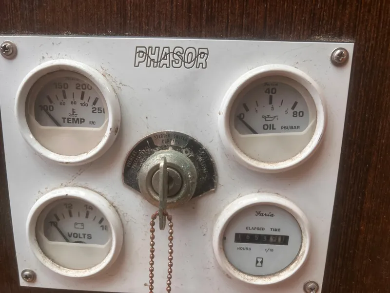 Slide: The Image of Control panel with gauges for temperature, oil pressure, volts, and elapsed time on a 1988 Young Brothers 40. - 21