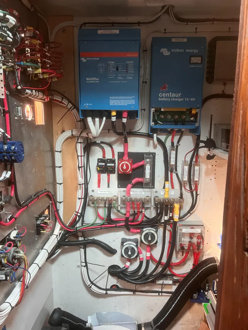 Slide: The Image of Electrical system setup in a 1988 Young Brothers 40 boat, featuring wiring and battery chargers. - 24