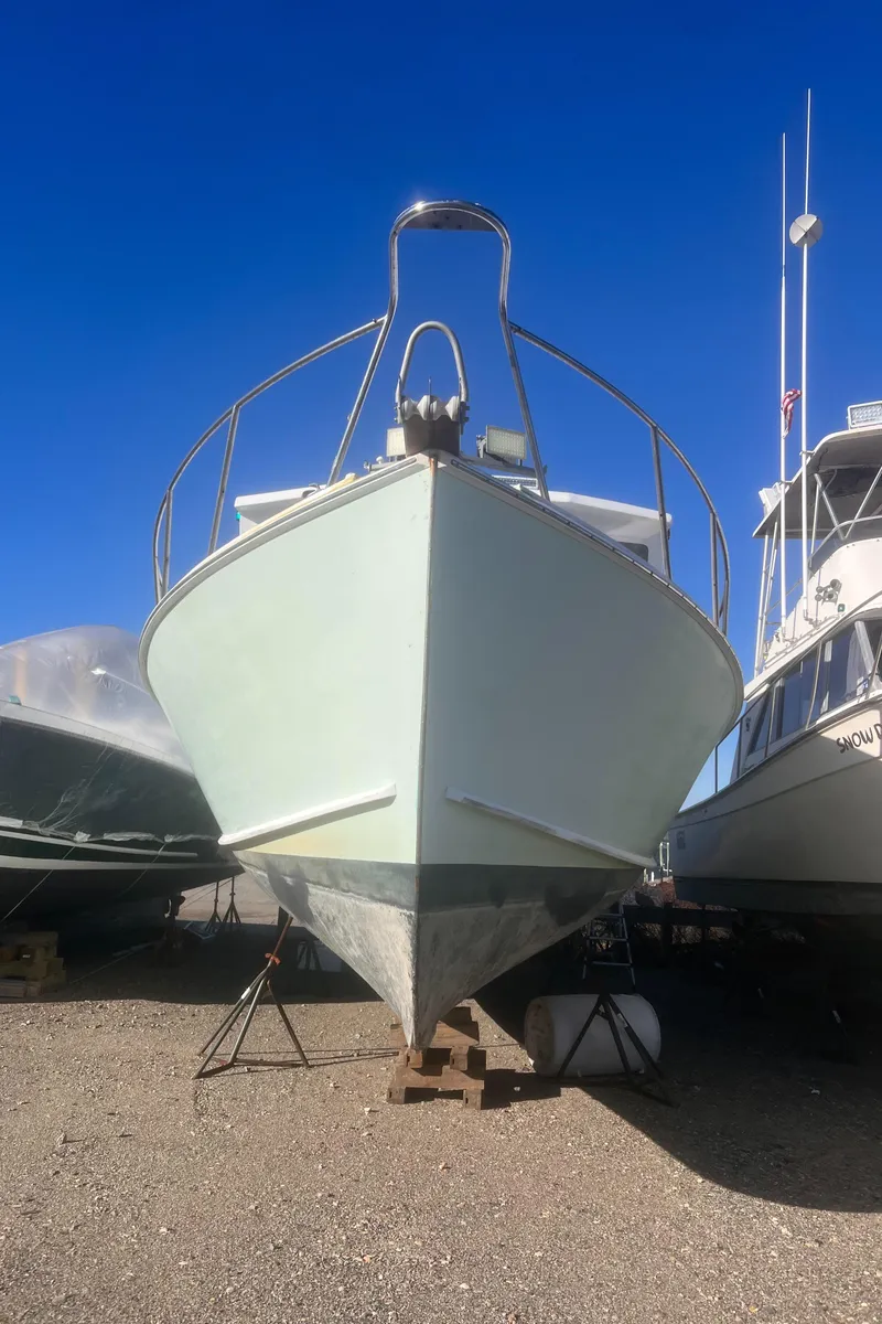 Slide: The Image of 1988 Young Brothers 40 boat on dry dock under clear blue sky. - 26