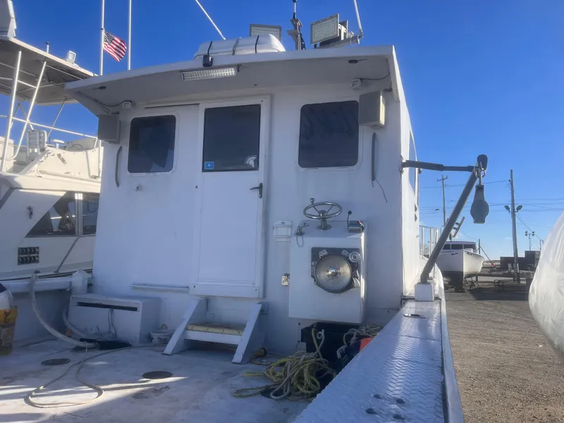 Slide: The Image of 1988 Young Brothers 40 boat with white cabin, docked under clear blue sky. - 7