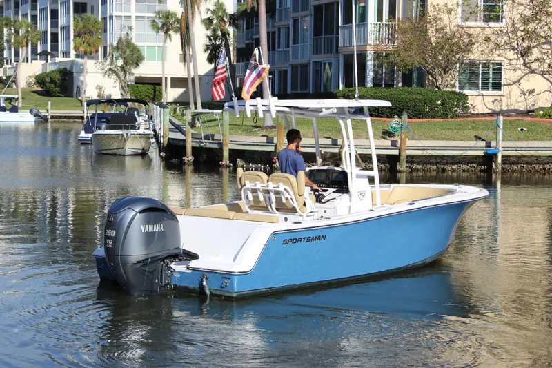 Slide: The Image of 2023 Sportsman Heritage 231 Center Console boat on calm water near residential area. - 13