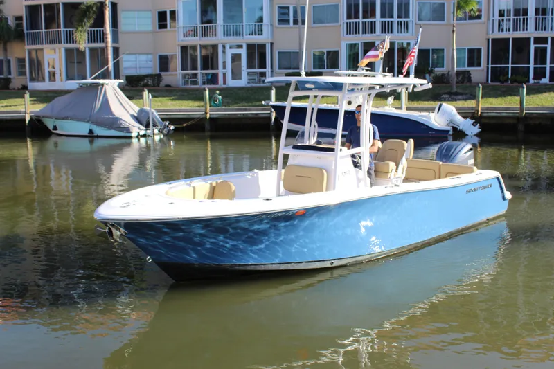 Slide: The Image of 2023 Sportsman Heritage 231 Center Console boat docked in a calm residential canal. - 14