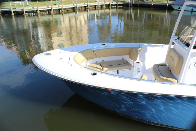 Slide: The Image of 2023 Sportsman Heritage 231 Center Console boat docked on calm water. - 16