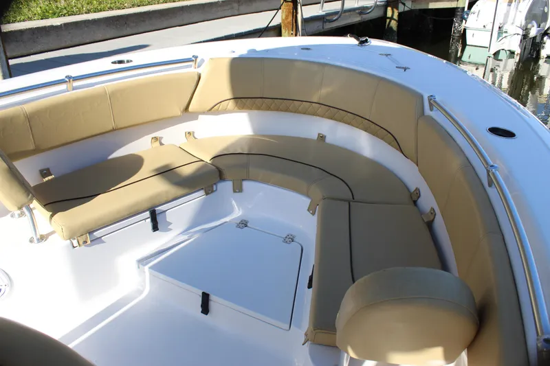 Slide: The Image of 2023 Sportsman Heritage 231 Center Console boat with beige seating in the bow area. - 20