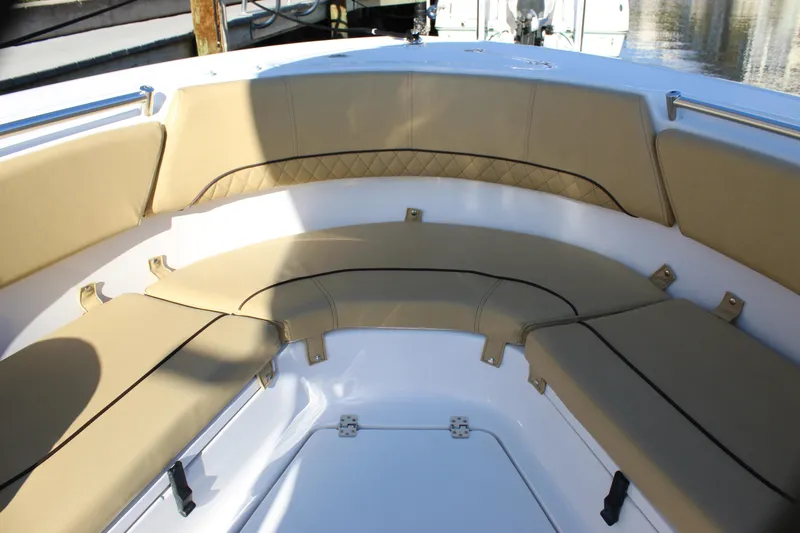 Slide: The Image of 2023 Sportsman Heritage 231 Center Console boat with tan cushioned seating. - 21