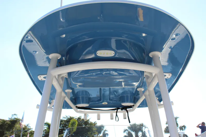 Slide: The Image of 2023 Sportsman Heritage 231 Center Console boat, blue T-top, viewed from below. - 27