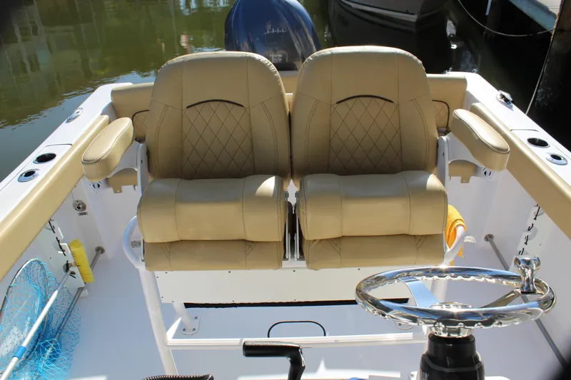 Slide: The Image of 2023 Sportsman Heritage 231 Center Console with tan seating and steering wheel. - 29