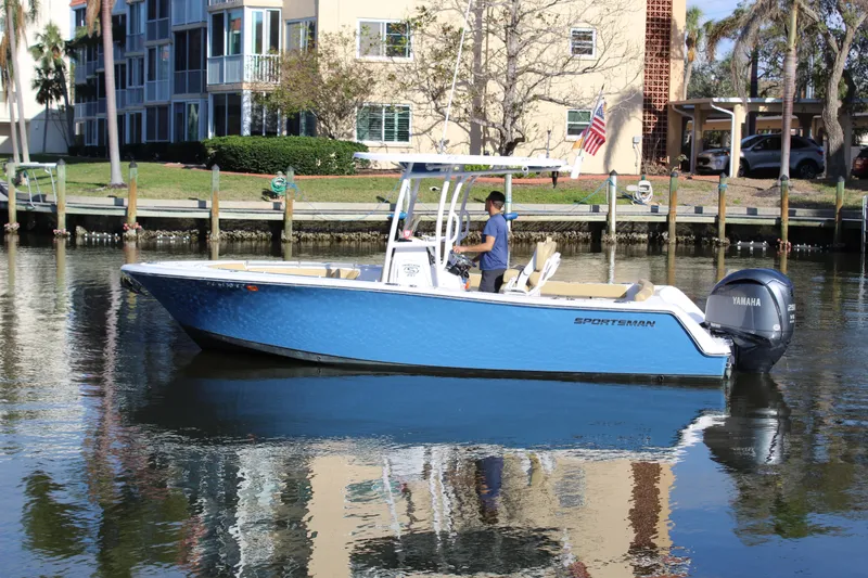 Slide: The Image of 2023 Sportsman Heritage 231 Center Console boat on calm water near residential area. - 3