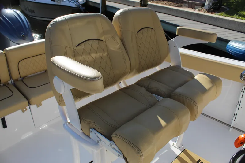 Slide: The Image of 2023 Sportsman Heritage 231 Center Console boat seats with tan upholstery and armrests. - 31