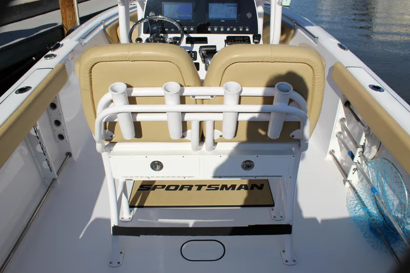 Slide: The Image of 2023 Sportsman Heritage 231 Center Console boat interior with dual seats and rod holders. - 32