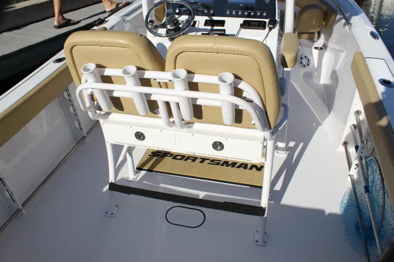 Slide: The Image of 2023 Sportsman Heritage 231 Center Console boat interior with tan seating and rod holders. - 33