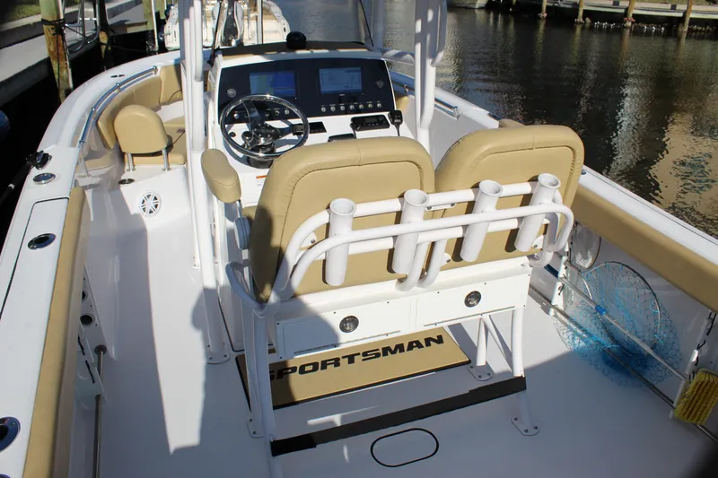 Slide: The Image of 2023 Sportsman Heritage 231 Center Console boat interior with beige seating and steering console. - 34