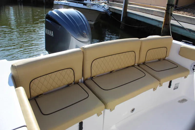 Slide: The Image of 2023 Sportsman Heritage 231 Center Console boat with tan cushioned seating and Yamaha outboard motor. - 37