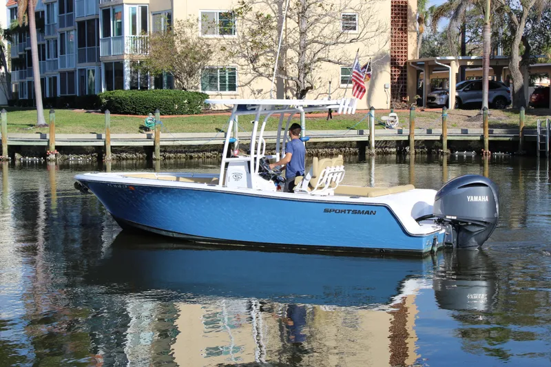 Slide: The Image of 2023 Sportsman Heritage 231 Center Console boat on calm water near residential area. - 4