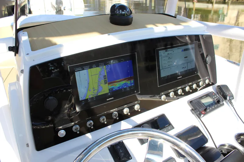 Slide: The Image of 2023 Sportsman Heritage 231 Center Console dashboard with navigation screens and controls. - 44