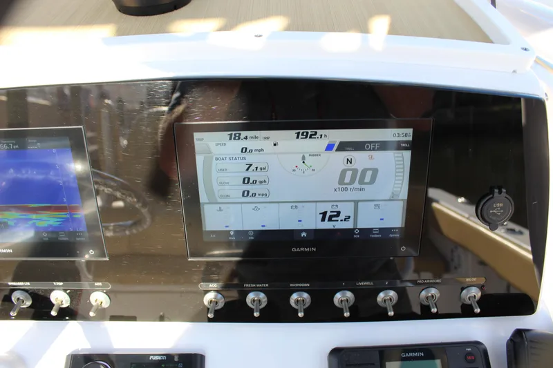 Slide: The Image of 2023 Sportsman Heritage 231 Center Console dashboard with digital display and controls. - 46