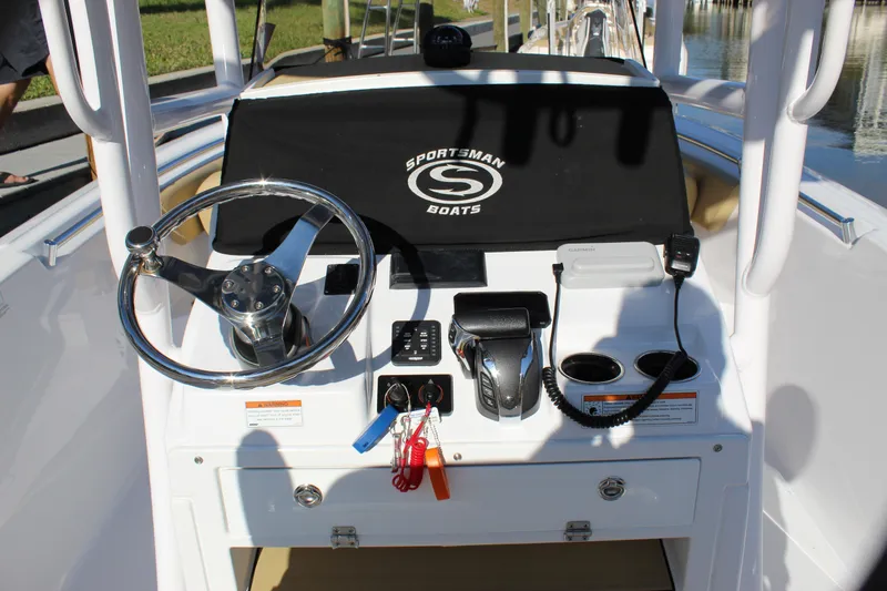 Slide: The Image of 2023 Sportsman Heritage 231 Center Console boat dashboard with steering wheel and controls. - 47
