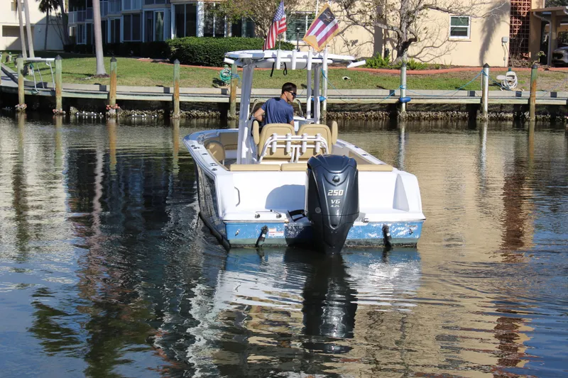 Slide: The Image of 2023 Sportsman Heritage 231 Center Console boat on calm water, rear view. - 7