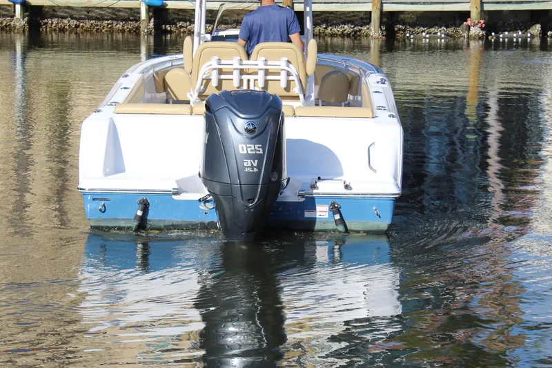 Slide: The Image of 2023 Sportsman Heritage 231 Center Console boat on water, rear view. - 8