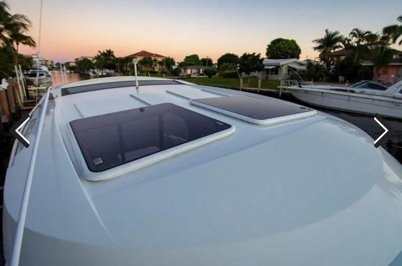 Slide: The Image of 2016 Jeanneau Merry Fisher 855 boat roof with skylights at sunset. - 35