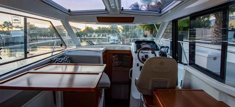 Slide: The Image of Interior of 2016 Jeanneau Merry Fisher 855 boat with helm and seating area. - 42