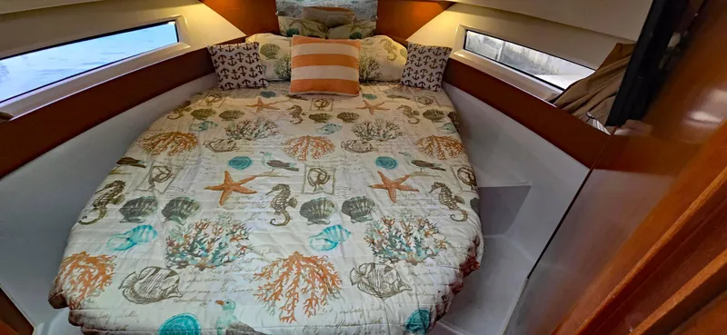 Slide: The Image of Cozy cabin interior of 2016 Jeanneau Merry Fisher 855 with nautical-themed bedding. - 9