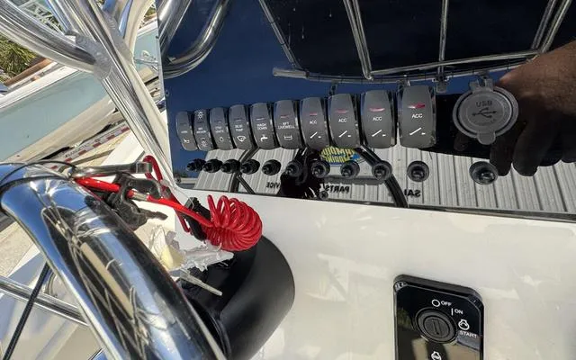 Slide: The Image of Control panel of 2025 Bulls Bay 200 CC boat with switches and USB port. - 24