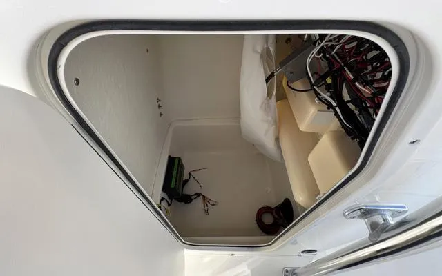 Slide: The Image of 2025 Bulls Bay 200 CC boat storage compartment with wiring and equipment. - 26