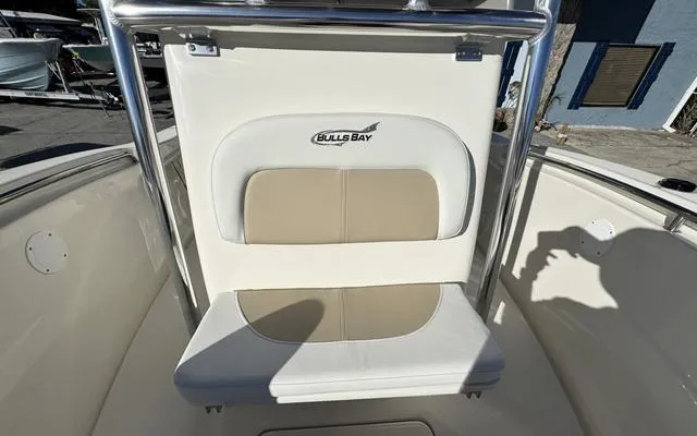 Slide: The Image of 2025 Bulls Bay 200 CC boat seat with logo, featuring beige and white upholstery. - 28