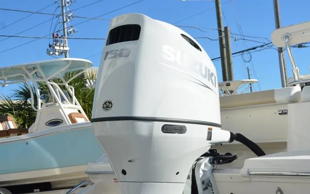 Slide: The Image of 2025 Bulls Bay 200 CC with Suzuki 150 outboard motor, docked under clear blue sky. - 9