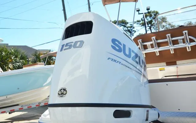 Slide: The Image of 2025 Pioneer 202 Islander boat with Suzuki 150 outboard motor, docked outdoors. - 10