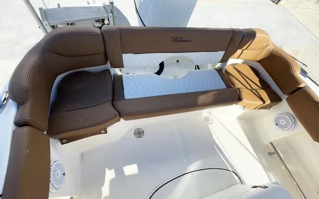 Slide: The Image of 2025 Pioneer 202 Islander boat interior with brown cushioned seating. - 16