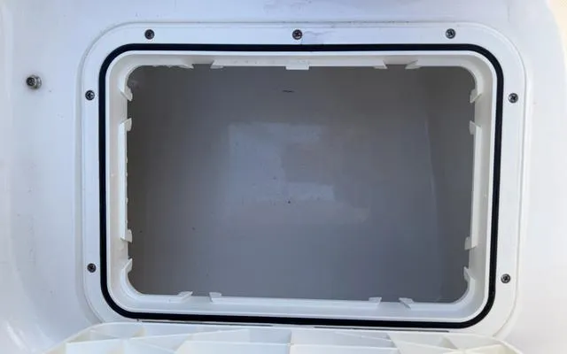 Slide: The Image of Storage compartment of 2025 Pioneer 202 Islander boat, open and empty. - 17