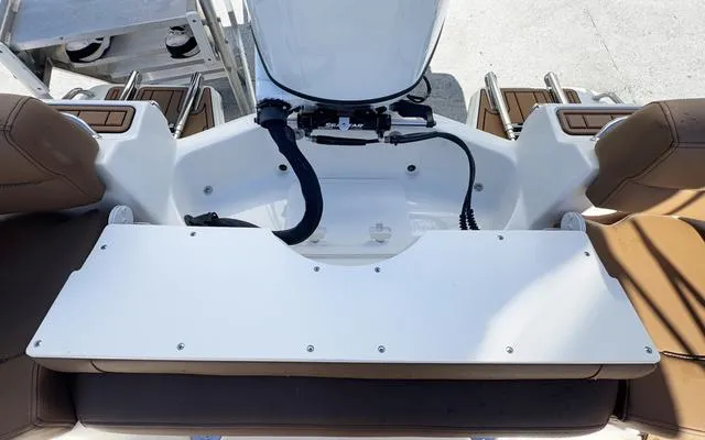 Slide: The Image of 2025 Pioneer 202 Islander boat interior with seating and engine area. - 19