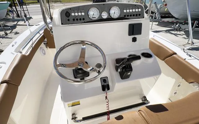 Slide: The Image of 2025 Pioneer 202 Islander boat dashboard with steering wheel and controls. - 22