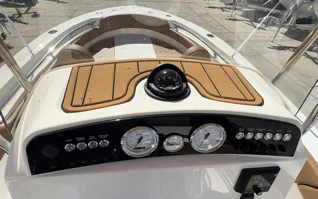 Slide: The Image of 2025 Pioneer 202 Islander boat dashboard with compass and gauges. - 24