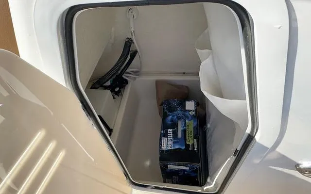 Slide: The Image of Storage compartment of 2025 Pioneer 202 Islander boat with a battery inside. - 27