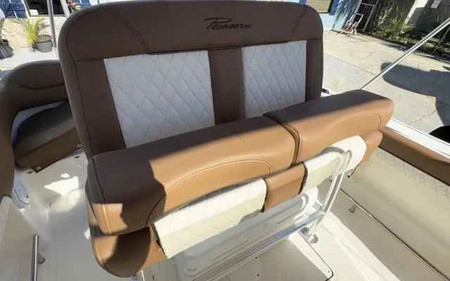 Slide: The Image of 2025 Pioneer 202 Islander boat seat with brown and white upholstery, outdoor setting. - 28