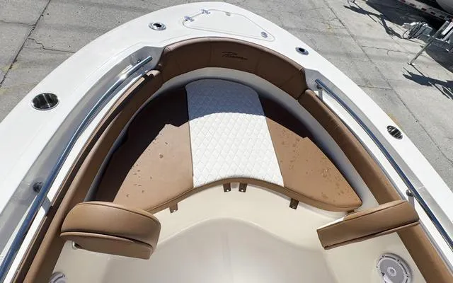 Slide: The Image of 2025 Pioneer 202 Islander boat interior with brown and white cushioned seating. - 31
