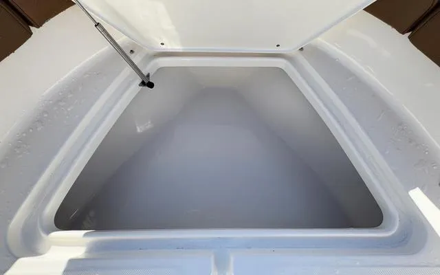 Slide: The Image of Open storage compartment on 2025 Pioneer 202 Islander boat. - 32