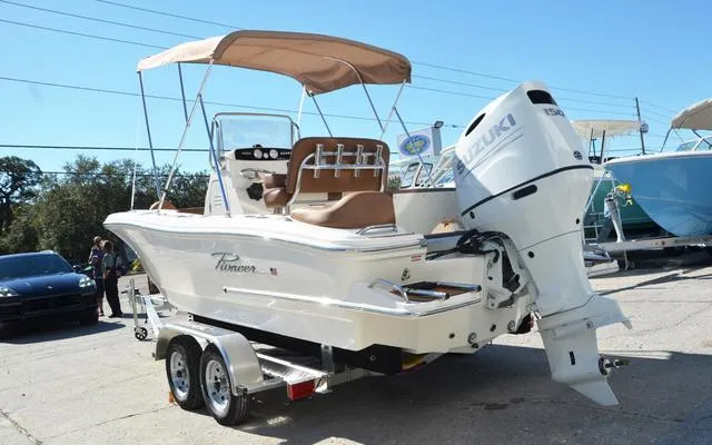 Slide: The Image of 2025 Pioneer 202 Islander boat with Suzuki outboard motor on a trailer. - 6