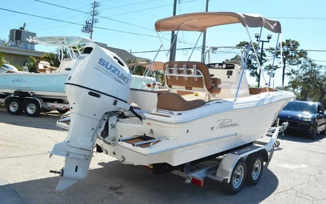 Slide: The Image of 2025 Pioneer 202 Islander boat with Suzuki outboard motor on a trailer. - 9