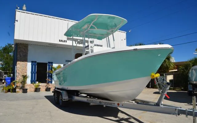 Slide: The Image of 2025 Clearwater 2200 boat on trailer outside sales and service building. - 1