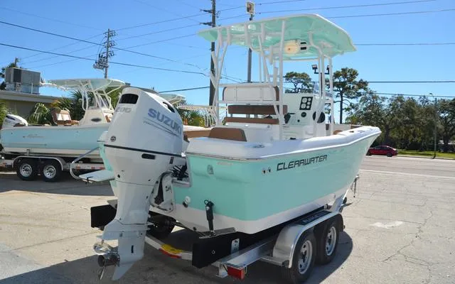 Slide: The Image of 2025 Clearwater 2200 boat with Suzuki engine on trailer, parked outdoors. - 10