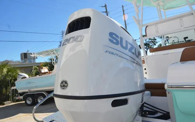 Slide: The Image of Clearwater 2200 boat with Suzuki 200 outboard motor, 2025 model, in a marina setting. - 11