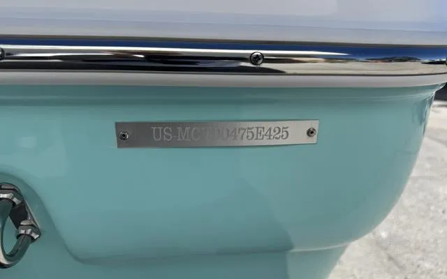 Slide: The Image of 2025 Clearwater 2200 boat hull with identification plate, light blue color. - 12
